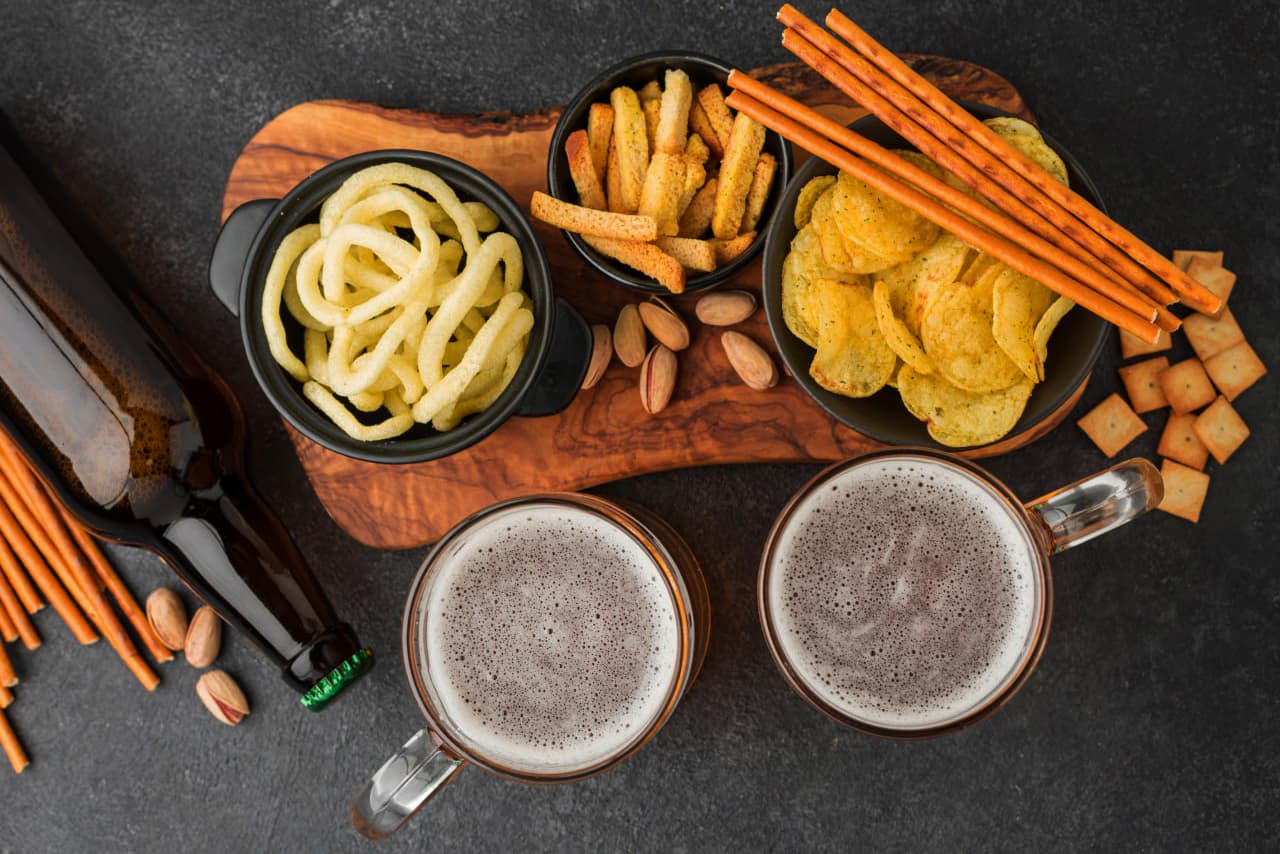Tasty snacks next to a wooden tray.